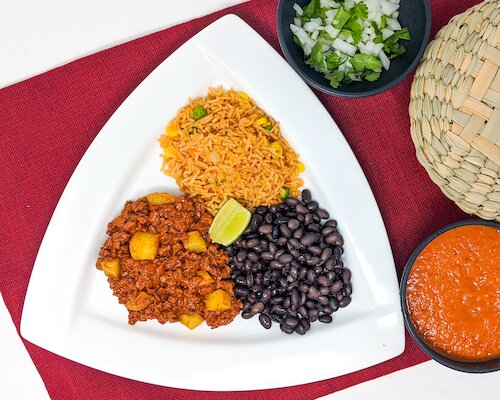 Vegan taco plate with soyrizo, potatoes, rice, beans, and salsa for catering}